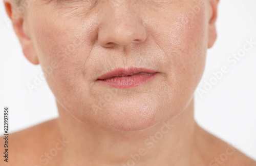 Beautiful older woman on white background, closeup of lips