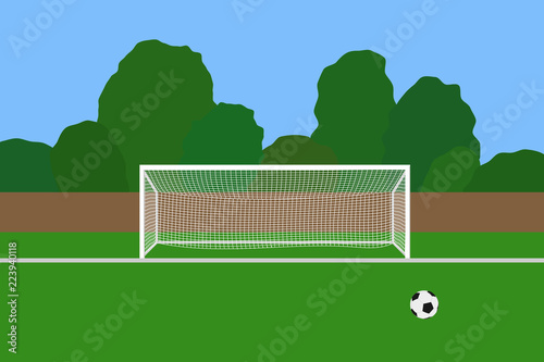 Soccer goal and ball on football stadium. Association football goal posts with net standing on a outdoor sports field