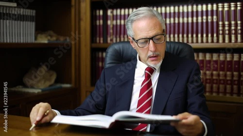 Businessman reading a book in his studio