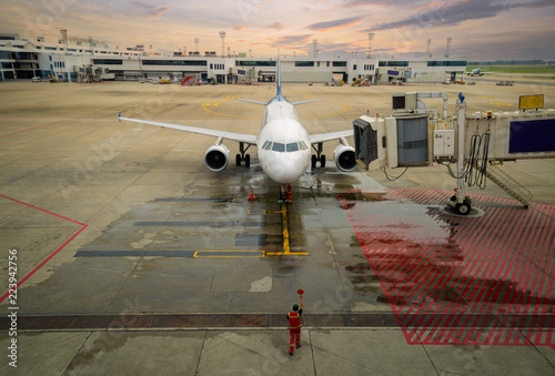 Flight officer give signal to pilot to parking aircraft in Don muang international airport. photo