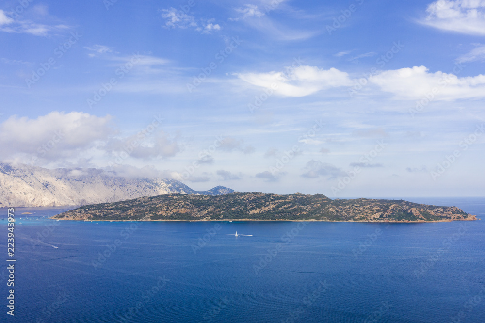 Spectacular aerial view of Tavolara's island bathed by a clear and turquoise sea, Sardinia, Italy.