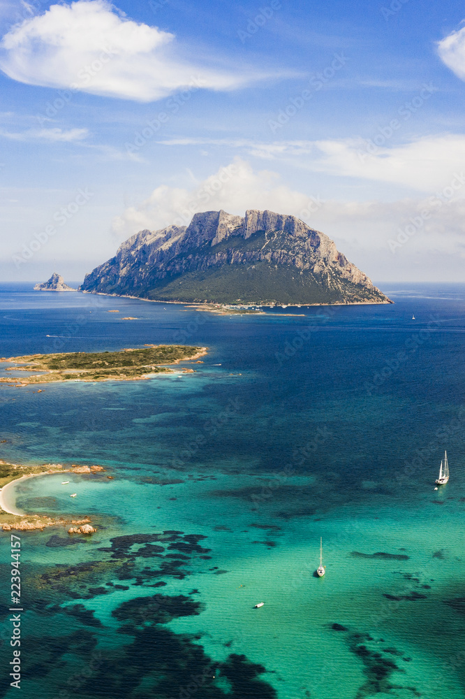 Spectacular aerial view of Tavolara's island bathed by a clear and turquoise sea, Sardinia, Italy.