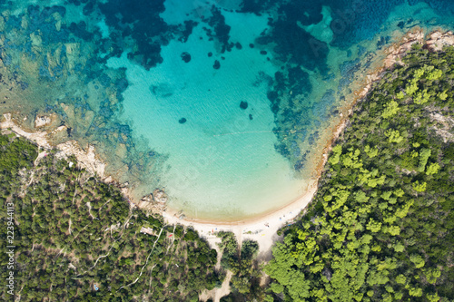 Fototapeta Naklejka Na Ścianę i Meble -  Spectacular aerial view of a beautiful wild beach bathed by a clear and turquoise sea, Sardinia, Italy.