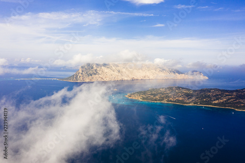 Spectacular aerial view of Tavolara's island bathed by a clear and turquoise sea, Sardinia, Italy.