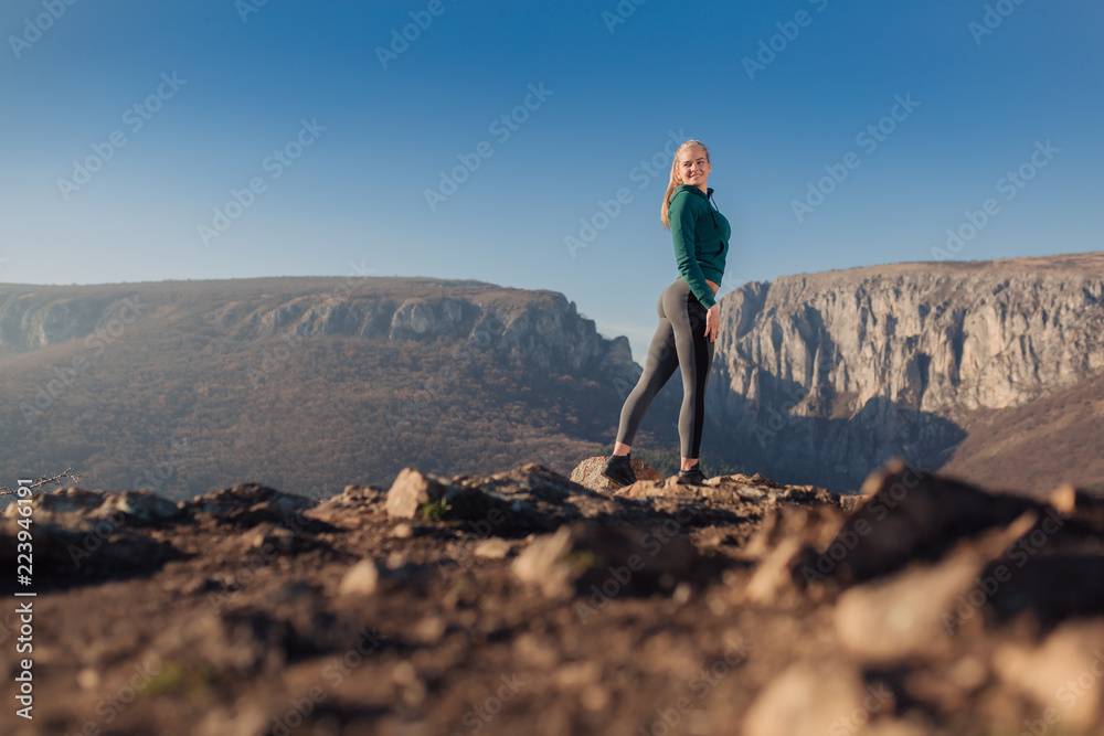 Young fit woman exercising on a mountain top Young fit woman exercising on a mountain top