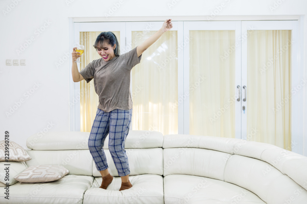 Asian woman expressing her happiness by dancing Asian woman expressing her happiness by dancing