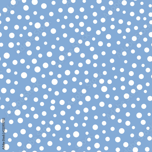 Seamless vector abstract pattern with circles scattered random in white and blue colors