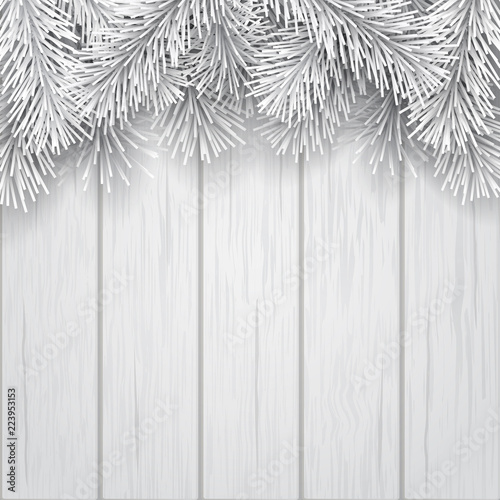White artificial Christmas tree branches on wooden background