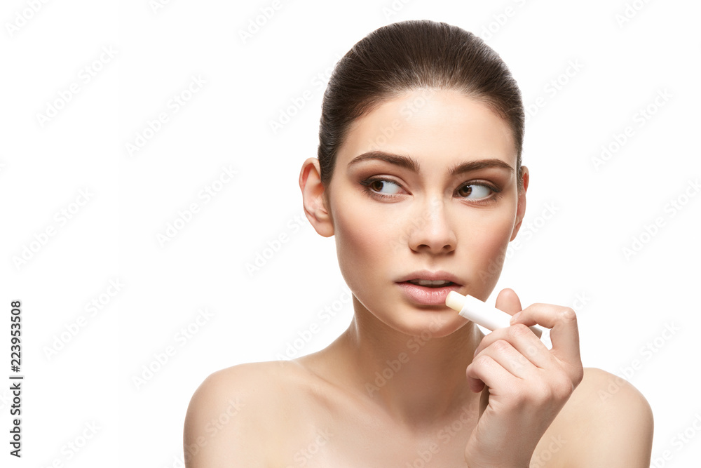 girl applying pink lipstick isolated on white girl applying pink lipstick isolated on white