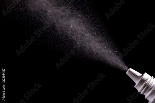 Spray for nose sprayed in the air on a black background