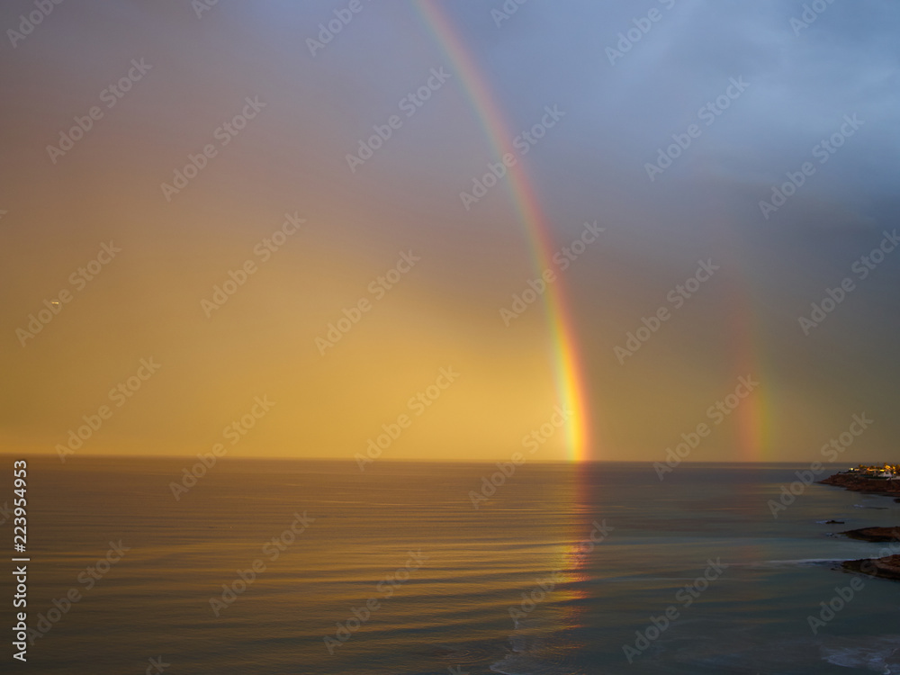 Rainbow over tropical sea ocean and sky