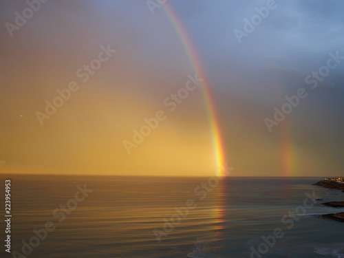 Rainbow over tropical sea ocean and sky