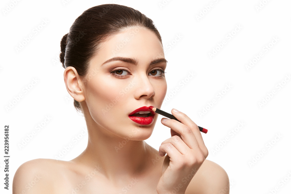 girl applying red lipstick isolated on white girl applying red lipstick isolated on white