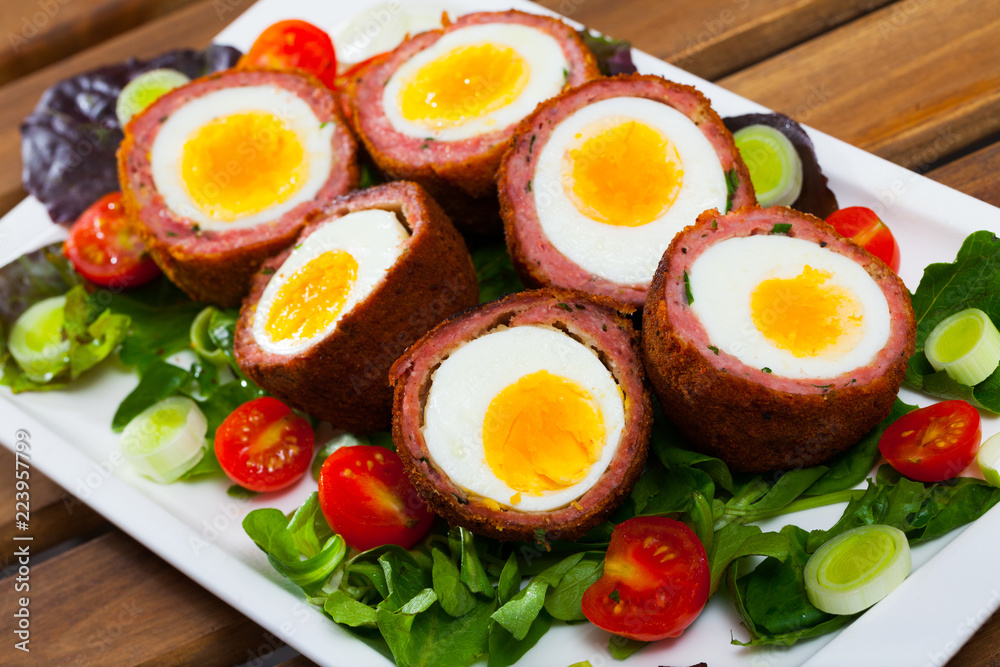 Scotch egg served with cherry tomatoes