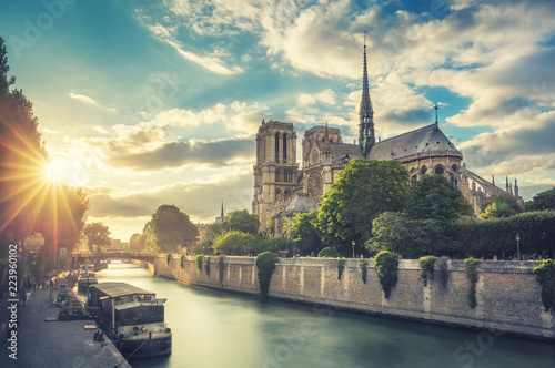 Notre Dame de Paris, France, and the Seine river at sunset. Scenic travel background.
