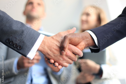 Business people shaking hands, finishing up a meeting. © ty