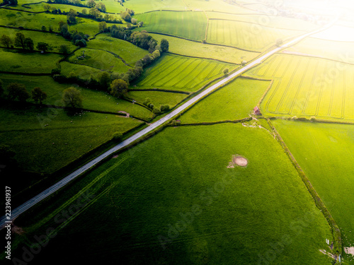 Obraz na plátne Aerial view looking down on a rural road in the UK countryside