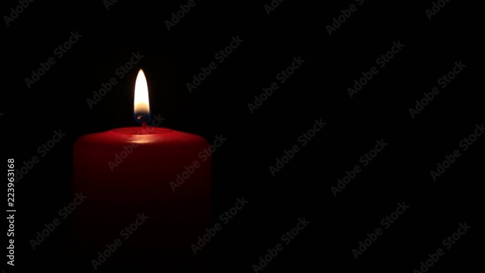 Candle burning close up on black background Candle burning close up on black background