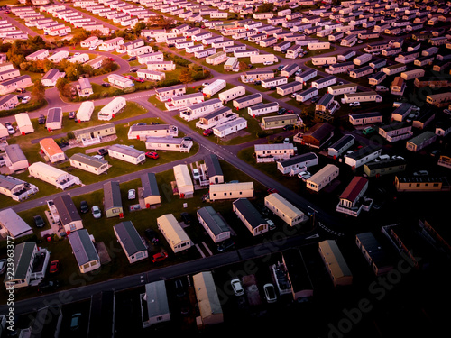 Sun Setting over the sea and Caravan and camping park, static home aerial view. Porthmadog holiday park taken from the air by a drone