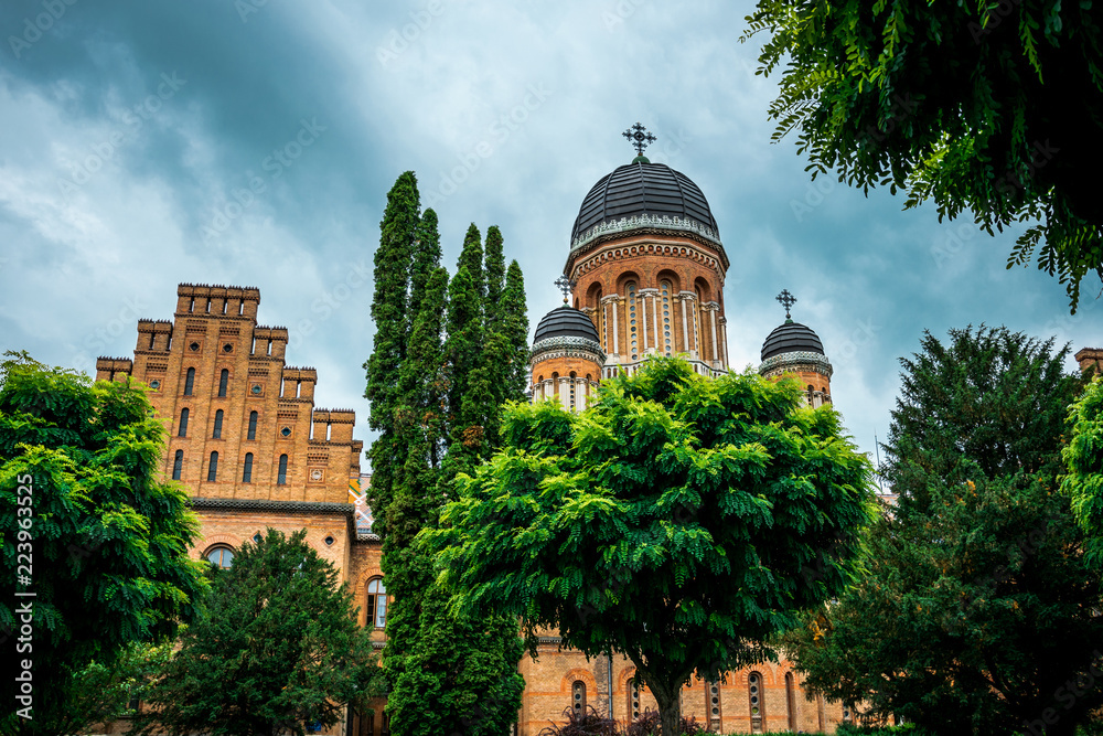 Ancient orthodox church and a summer flowering garden