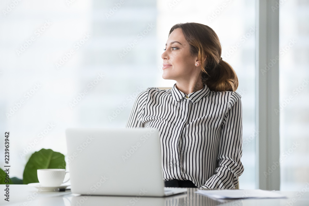 Thoughtful businesswoman looking to side dreaming about future success, smiling female boss or ceo distracted from work thinking about something, looking through window of modern office building Thoughtful businesswoman looking to side dreaming about future success, smiling female boss or ceo distracted from work thinking about something, looking through window of modern office building