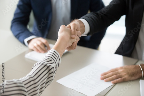 Schilderij op canvas Close up of male recruiter shaking hand of female job applicant greeting with su
