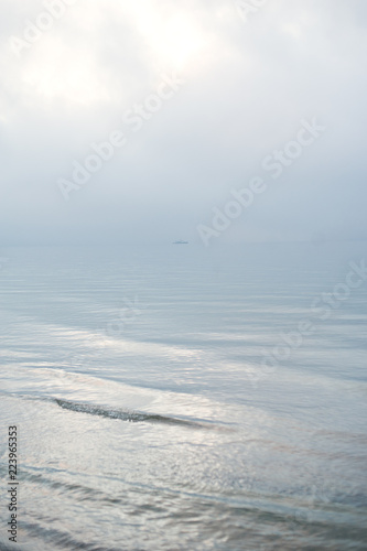 Quiet waters of the ocean and the ship in are far