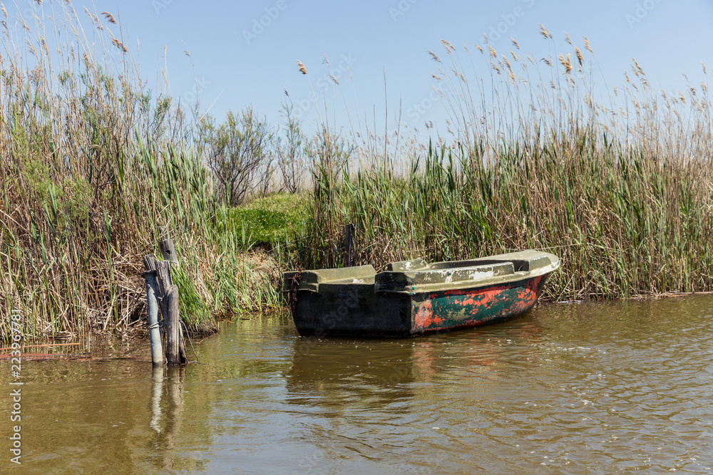 Wooden fishing boat on a river in northern Greece Wooden fishing boat on a river in northern Greece