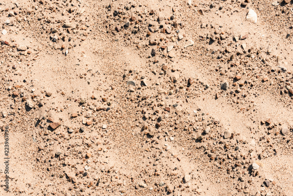 Sand with small stones - natural background with copy space Sand with small stones - natural background with copy space