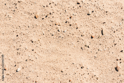 Sand with small stones - natural background with copy space