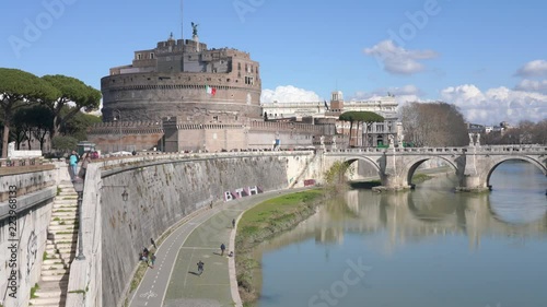 Italy, Rome - February 13, 2018: A running man on the Tiber River embankment near the castle of Sant'Angelo, 4K