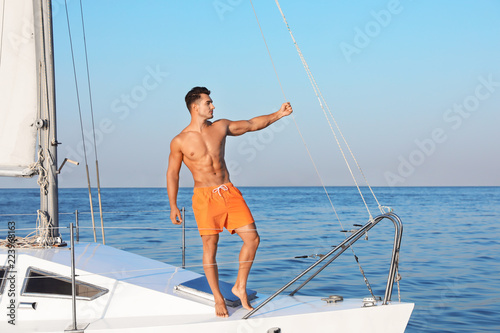 Young man relaxing on yacht during sea trip