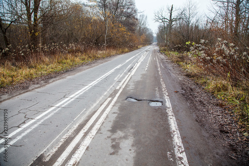old abandoned asphalt road with spoiled road markings © Radnatt