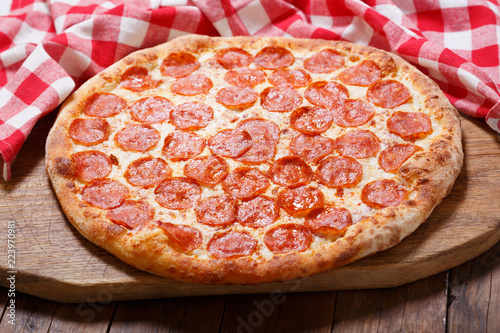 Pizza pepperoni on wooden table