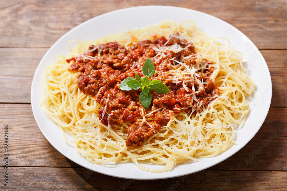 plate of pasta bolognese on wooden table plate of pasta bolognese on wooden table
