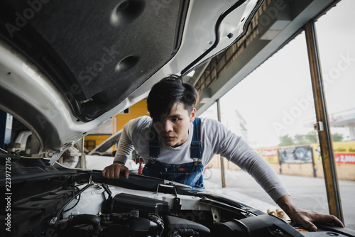 Young Asian machine technicians are analyzing symptoms of broken car at service center repair