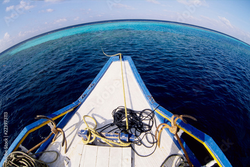 Tourist sailing between the coralline islands atoll of felidu indian ocean maldives photo