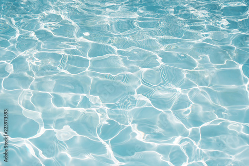 Texture of water in swimming pool for background © jintana