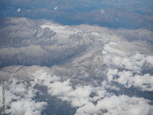 Flying over the European Alps during summer season. Landscape at the glaciers. Aerial view from the airplane window © Matteo Ceruti