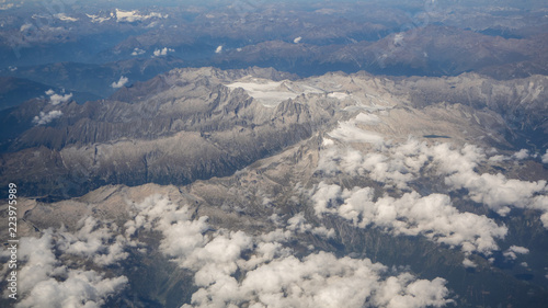 Flying over the European Alps during summer season. Landscape at the glaciers. Aerial view from the airplane window © Matteo Ceruti