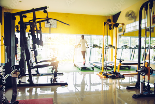 Blur the gym with exercise equipment and light in the morning.