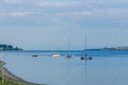 Boats anchoring in the evening on silent lake water
