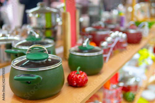 Kitchen pans on shelf in store.