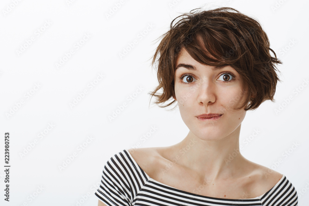 Dreamy good-looking feminine girl with short stylish haircut, smiling and  smirking while gazing flirty at camera, expressing positive attitude, being  amused with nice talk with guy during date Stock Photo | Adobe