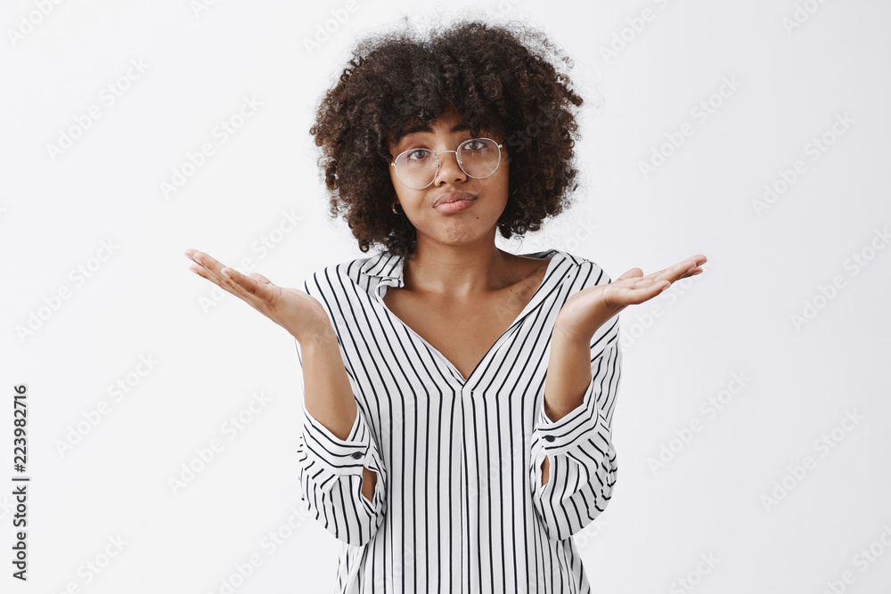 Waist-up shot of upset woman losing in battle shrugging with spread palms aside pursing lips and frowning from disappointment and regret being unhappy and gloomy after bad result over gray wall Waist-up shot of upset woman losing in battle shrugging with spread palms aside pursing lips and frowning from disappointment and regret being unhappy and gloomy after bad result over gray wall