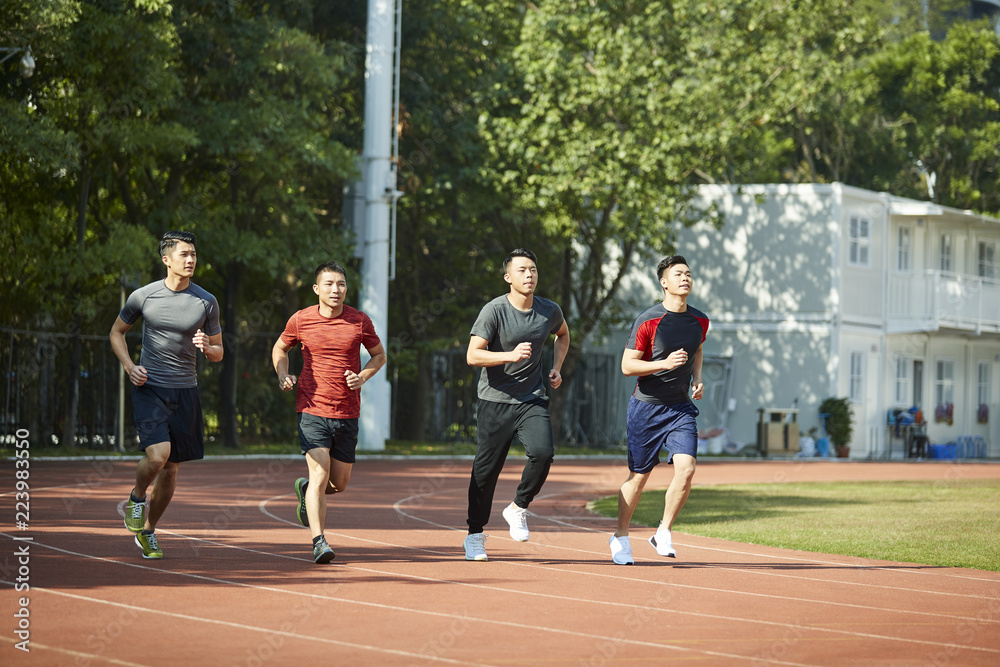 asian young adults running on track