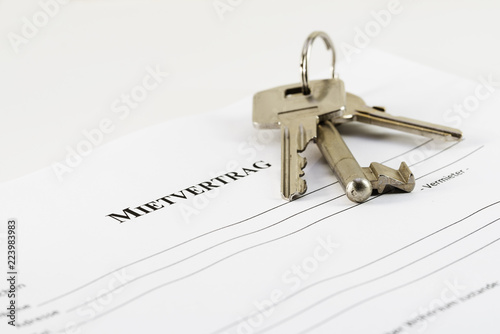 German lease agreement document with house keys, Mietvertrag means rental contract,copy space