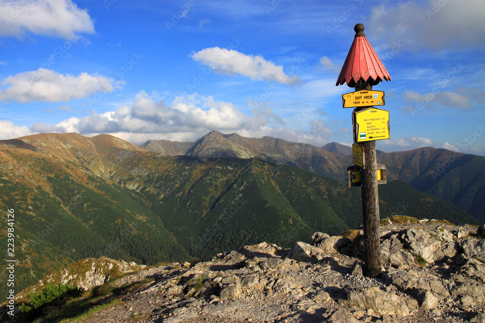 TANAP signe on the top of Sivy vrch and the view on Western Tatra Mountains (Salatin on the left), Slovakia