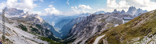Wide pano shot of the Auronzo refuge taken from the tree peaks of lavaredo (tre cime di lavaredo, drei zimmen) where you can see the auronzo di cadore valley and the footpath of the park photo