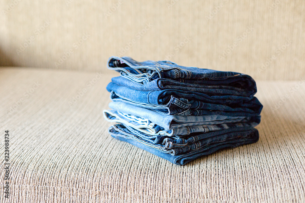 Stack of blue jeans.Shades of denim fabric. Stack of blue jeans.Shades of denim fabric.